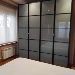 Mueble de la habitación con una ventana y radiador debajo